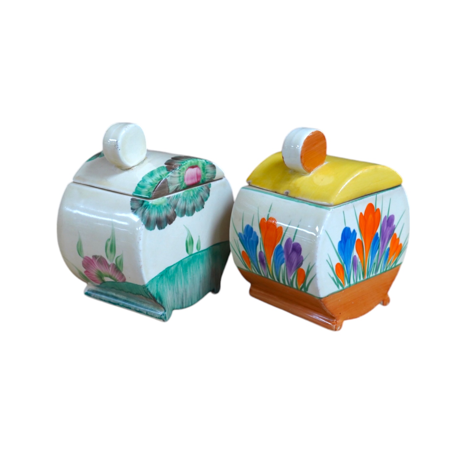 Two Clarice Cliff drum shaped preserve pots and covers, one in Crocus pattern and the other in Viscaria pattern. Condition - good